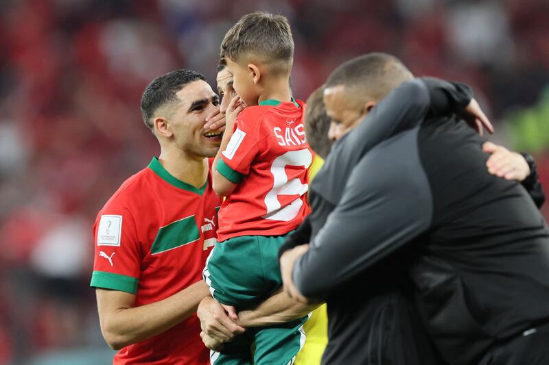 Moroccan defender Achraf Hakimi, left, with Romain Saiss and his son. AFP