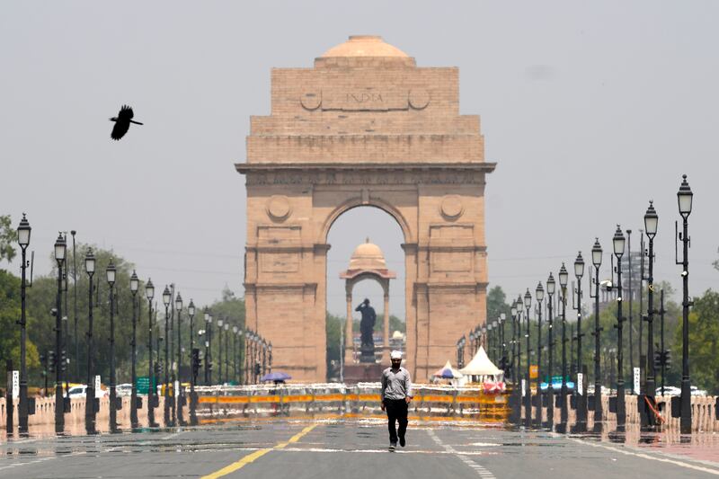 A man walks past the India Gate monument on a hot summer day in New Delhi. AP