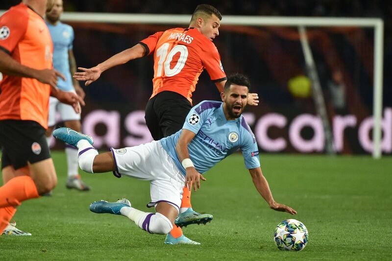 Shakhtar Donetsk's Ukraine forward Junior Moraes and Manchester City's Algerian midfielder Riyad Mahrez in action at the OSK Metalist Stadium in Kharkiv. The Champions League Group C match ended in a 3-0 win for City. AFP