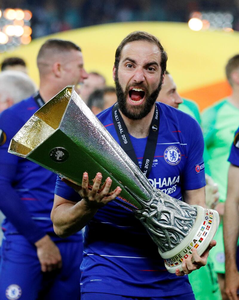 Chelsea's Gonzalo Higuain celebrates winning the Europa League with the trophy. REUTERS