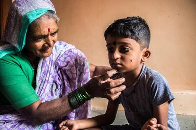 Kusum Gaikwad applies kohl to her grandson, Yash, 5. Sanket Jain for The National