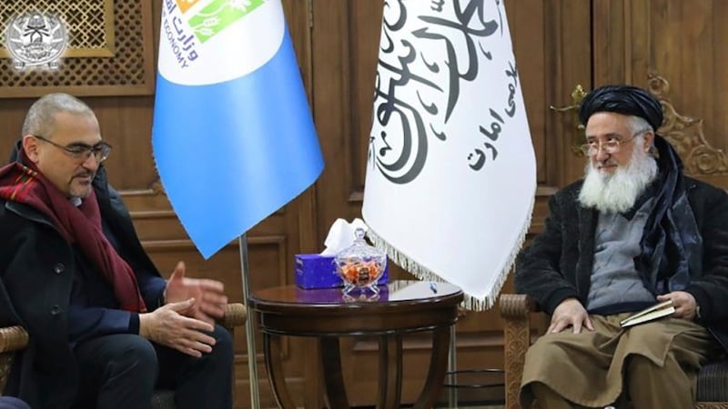 The UN's Ramiz Alakbarov, left, with Taliban economy minister, Qari Din Mohammed Hanif, after the NGO ban. AP