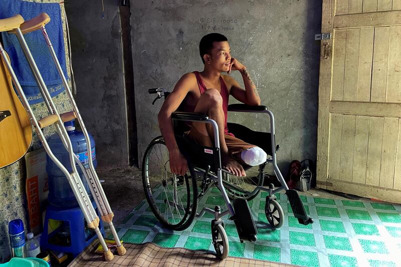 Ko Phyo, 24, a protester who lost a leg after being shot by a soldier during an anti-coup protest, sits in a wheelchair at his home on the outskirts of Yangon, Myanmar. Reuters