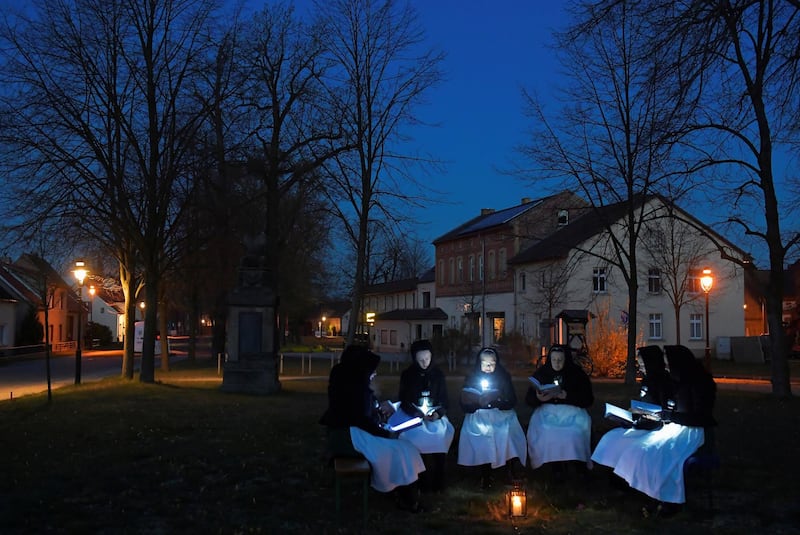 Women dressed in traditional clothes of the Slavic ethnic minority community of Sorbs meet early Easter Sunday to sing in front of a church in Schleife, eastern Germany. Reuters