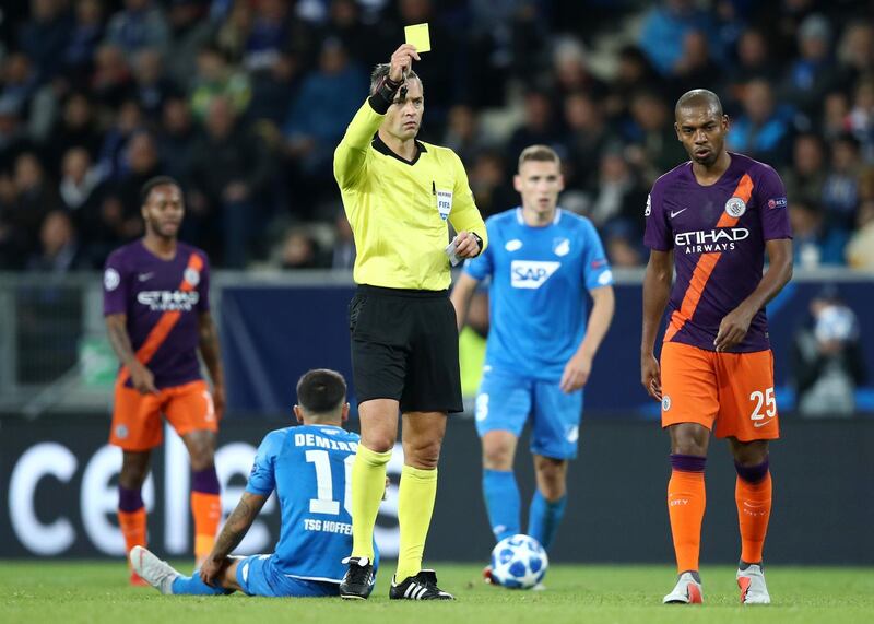 Referee Damir Skomina shows a yellow card to Fernandinho of Manchester City. Getty Images