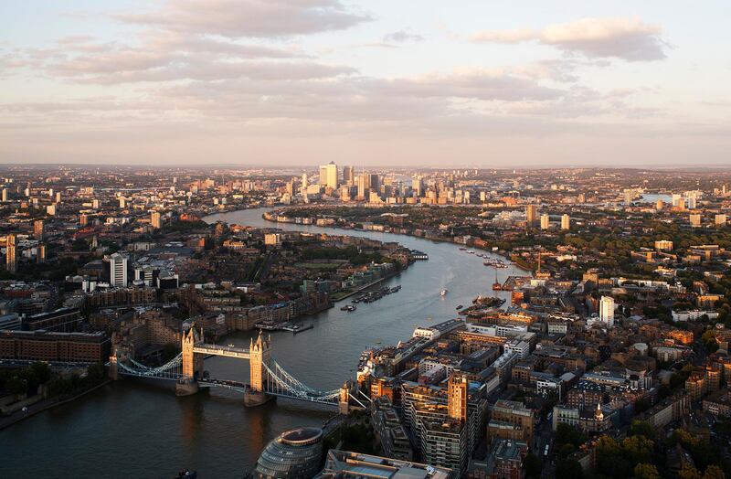 UK,London,elevated view over the City of London along the River Thames with the City and Tower Bridge at sunset