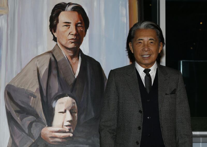 Fashion designer Kenzo Takada posing next to his self-portrait painting during the Monaco Fight Aids Gala, in Monaco, on December 1, 2014. AFP