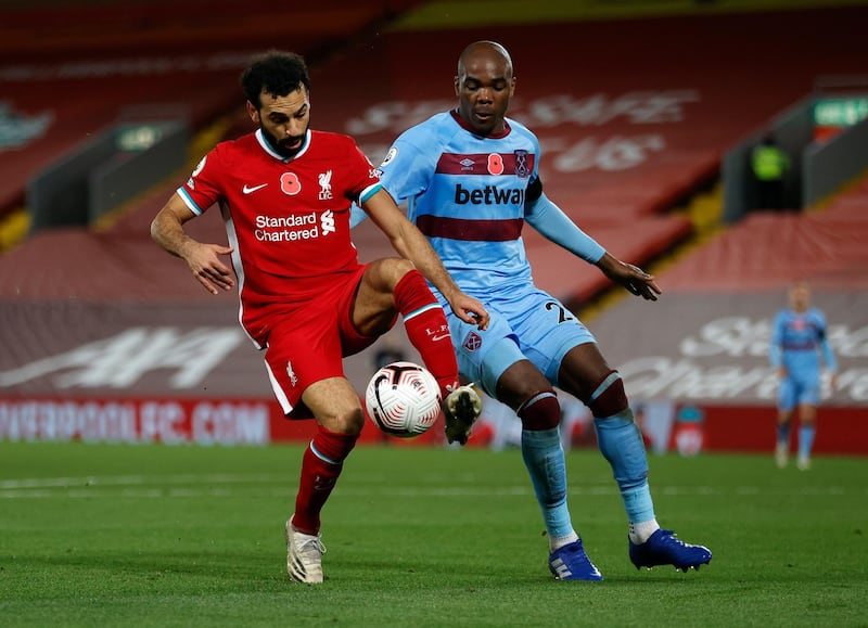Liverpool forward Mohamed Salah battles for possession with Angelo Ogbonna. Getty Images