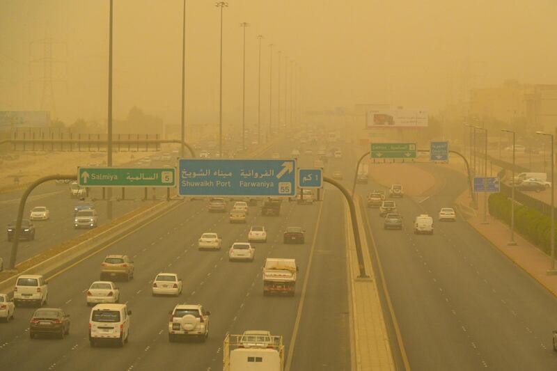 Vehicles travel through Kuwait City in dusty weather. EPA
