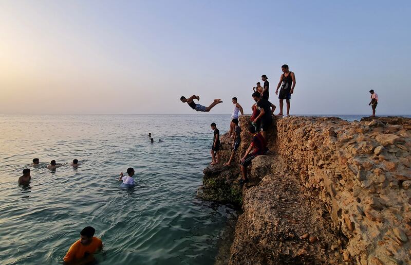 Libyan youths gather at a cliff by the Mediterranean Sea in the capital Tripoli. Young Libyans were polled in Tripoli, Misrata and Benghazi for the 2021 Arab Youth Survey. Photo: Mahmud Turkia / AFP