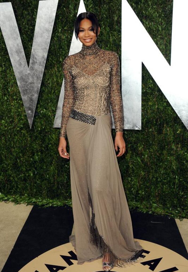 Model Chanel Iman donning a fabulous Rami Al Ali taupe beaded-tulle and chiffon high-necked gown for the Vanity Fair Oscar Party in 2013. AP