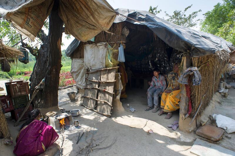 8th April 2013, Shakarpur, New Delhi, India. Veeresh Kumar (9) sits with his grandmother in the doorway of his home located on the banks of the Yamuna River while a relative cooks breakfast, Shakarpur, New Delhi, India on the 8th April 2013. He attends the makeshift school under a metro bridge near the Yamuna Bank Metro station nearby and particularly likes Maths and English his parents are market gardeners.
 
Rajesh Kumar Sharma (40), started this makeshift school a year ago. Five days a week, he takes out two hours to teach when his younger brother replaces him at his general store in Shakarpur. His students are children of labourers, rickshaw-pullers and farm workers. This is the 3rd site he has used to teach under privileged children in the city, he began in 1997 fifteen years ago. 

PHOTOGRAPH BY AND COPYRIGHT OF SIMON DE TREY-WHITE

+ 91 98103 99809
+ 91 11 435 06980
+44 07966 405896
+44 1963 220 745
email: simon@simondetreywhite.com