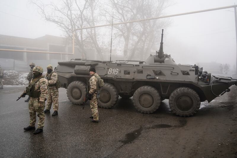 Kazakh soldiers guard a road in Almaty. The country's largest city has experienced days of violent unrest. Photo: AP