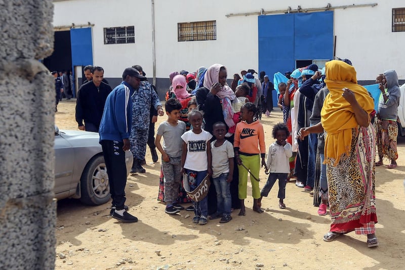 Migrants gather to meet Antonio Guterres during his visit to Ain Zara detention centre for migrants. AFP