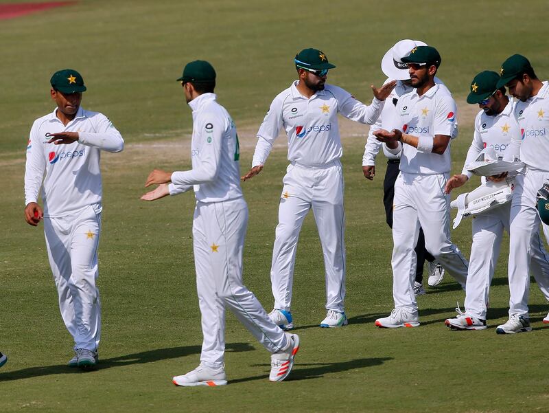 Pakistan's sipper Babar Azam, centre, with teammate Hasan Ali, third right, after dismissing South Africa on Friday. AP