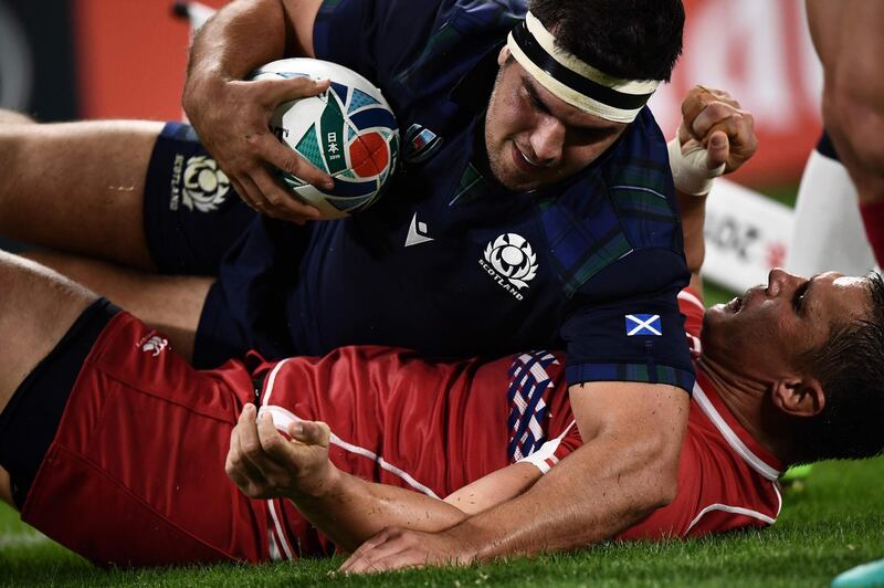 Scotland's hooker Stuart McInally (up) scores a try  during the Japan 2019 Rugby World Cup Pool A match between Scotland and Russia at the Shizuoka Stadium Ecopa in Shizuoka. AFP