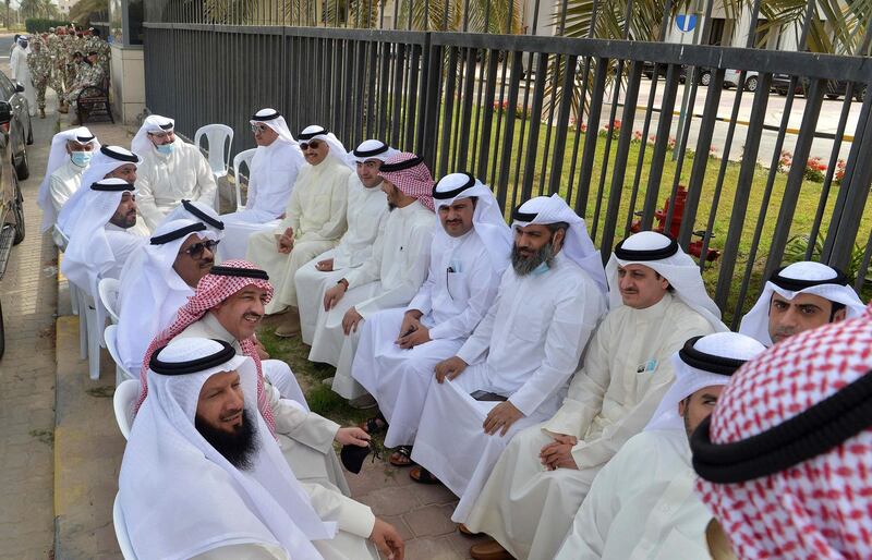 Kuwaiti opposition MPs gather outside the parliament building in Kuwait. AFP