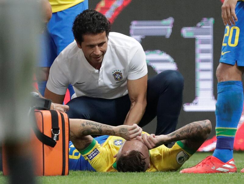 Brazil's Everton Soares receives treatment after sustaining an injury. Reuters