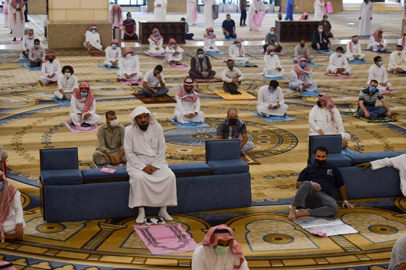 Saudi Muslim worshippers observe a safe distance as they perform noon prayer at Al Rajhi mosque in the capital Riyadh. AFP