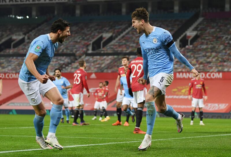 Soccer Football - Carabao Cup - Semi Final - Manchester United v Manchester City - Old Trafford, Manchester, Britain - January 6, 2021 Manchester City's John Stones celebrates scoring their first goal with teammates Pool via REUTERS/Shaun Botterill EDITORIAL USE ONLY. No use with unauthorized audio, video, data, fixture lists, club/league logos or 'live' services. Online in-match use limited to 75 images, no video emulation. No use in betting, games or single club /league/player publications.  Please contact your account representative for further details.     TPX IMAGES OF THE DAY