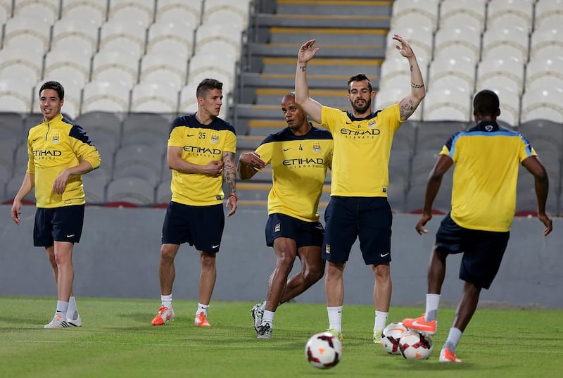 Samir Nasri, far left, Stevan Jovetic, second left, Vincent Kompany, centre, and Alvaro Negredo, second right, during Wednesday night's Manchester City training session in Abu Dhabi. Satish Kumar / The National / May 14, 2014