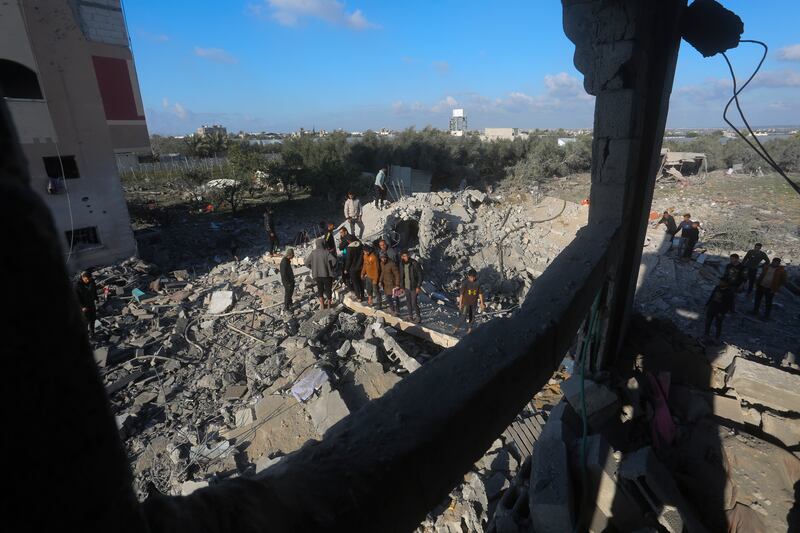 Palestinians search for survivors after an Israeli airstrike on a residential building In Rafah, Gaza Strip. AP