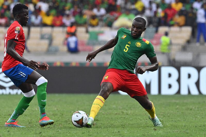 Cameroon's defender Michael Ngadeu-Ngadjui, right, is challenged during the Afcon quarter-final against Gambia at the Japoma Stadium in Douala. AFP