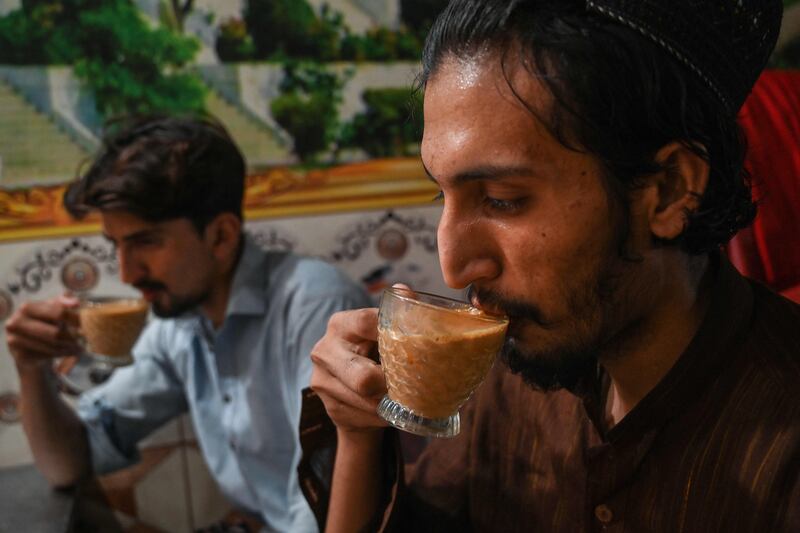 Men drink tea at a restaurant in Islamabad. AFP