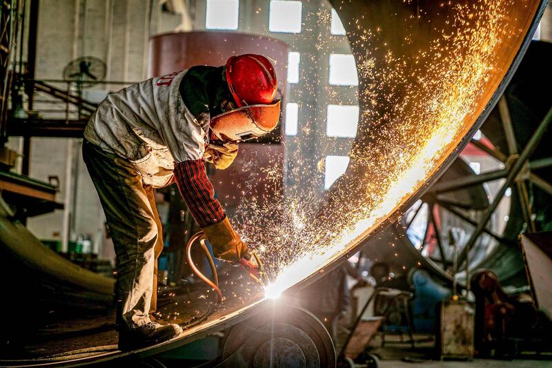 Sparks fly as a worker goes about his duty at a factory in Nantong in China's eastern Jiangsu province. AFP