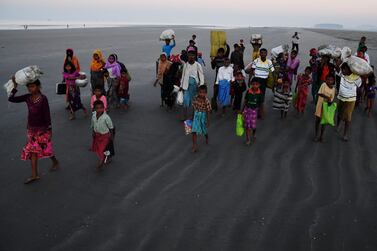 Rohingya Muslim refugees who entered Bangladesh by boat walk towards refugee camps after landing at the Saplapur beach in the Teknaf district. When hundreds of thousands of Rohingya fled Myanmar into Bangladesh two years ago, local communities were mostly welcoming. Today that welcome has worn thin. AFP