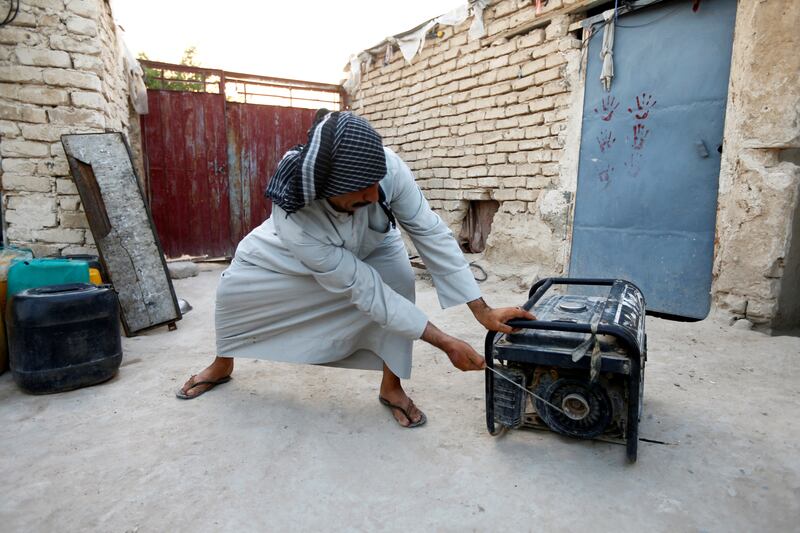 FILE PHOTO: A man activates his personal electrical generator at home to help cope with a series of power outages in Najaf, Iraq, July 14, 2020. REUTERS/Alaa Al-Marjani/File Photo