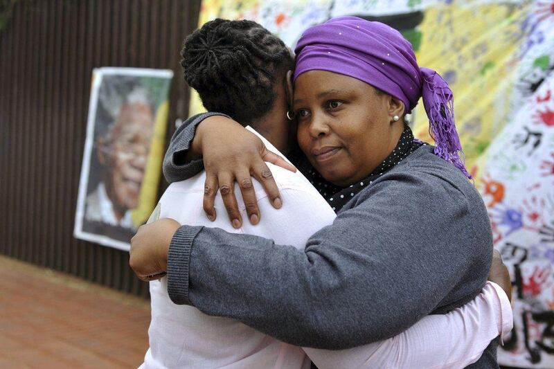 Two women console each other on Vilakazi Street in Soweto, where former South African President Nelson Mandela resided when he lived in the township. Mandela's death is being mourned in South Africa and around the world. Ihsaan Haffejee / Reuters