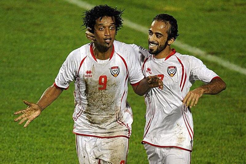 Mohammed Al Shehhi, left, celebrates his 39th minute opener with UAE teammate Ali Al Wehaibi in tricky conditions against India in Delhi.

Prakash Singh / AFP