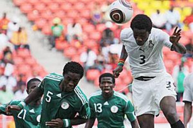 Ghana's Asamoah Gyan, right, gets in front of the Nigeria defenders to head home the only goal of the game - his third of the tournament.