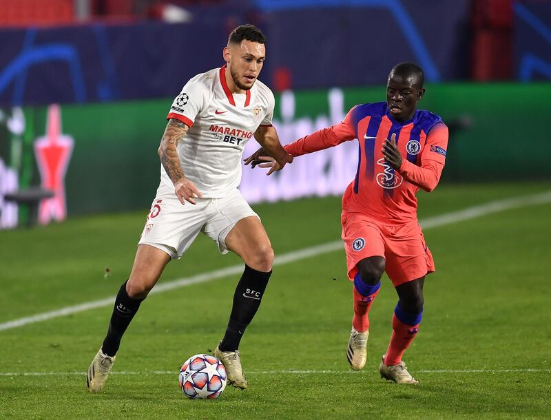 SEVILLE, SPAIN - DECEMBER 02: Lucas Ocampos of FC Sevilla looks to break past Nâ€™golo Kante of Chelsea  during the UEFA Champions League Group E stage match between FC Sevilla and Chelsea FC at Estadio Ramon Sanchez Pizjuan on December 02, 2020 in Seville, Spain. Sporting stadiums around Spain remain under strict restrictions due to the Coronavirus Pandemic as Government social distancing laws prohibit fans inside venues resulting in games being played behind closed doors. (Photo by David Ramos/Getty Images)