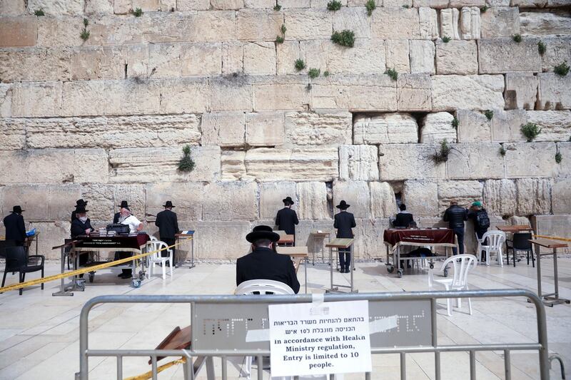 Ultra-orthodox Jews practice social distancing while praying at the Western Wall in Jerusalem. AP Photo