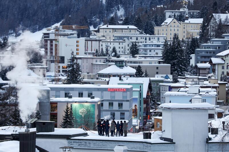 Security personnel stand on a rooftop for a briefing ahead of WEF. Bloomberg