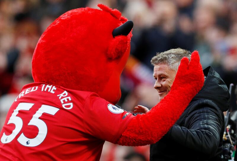 Manchester United manager Ole Gunnar Solskjaer with their mascot before the match. Reuters