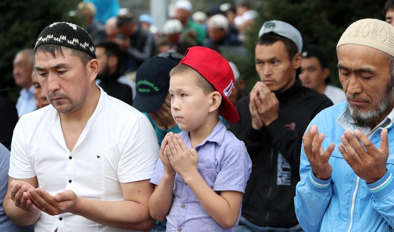 Kyrgyz people pray during at the central square in Bishkek, Kyrgyzstan.  EPA