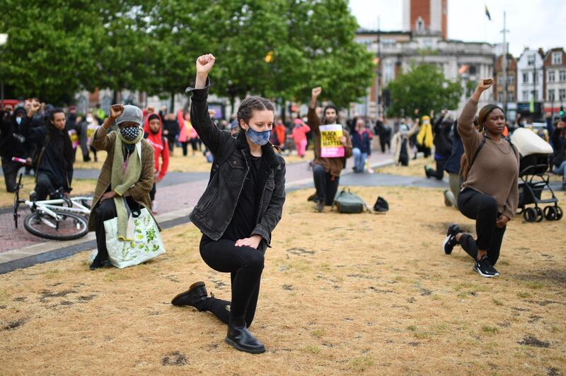 Protestors take part in a Take The Knee demonstration in solidarity with Black Lives Matter in Windrush Square, Brixton, south west London.  AFP