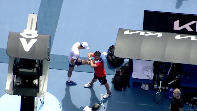 Novak Djokovic is seen stretching during practice at Melbourne Park following his release from federal detainment. Reuters