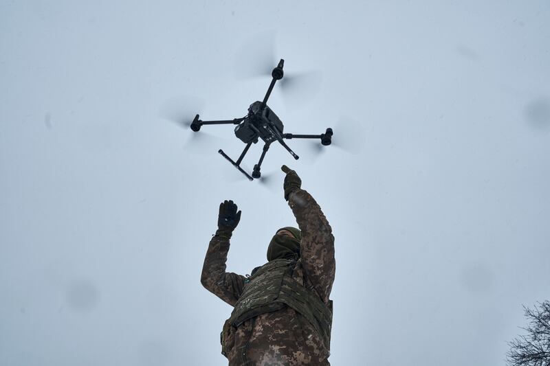 A Ukrainian soldier launches a drone close to the front line near Avdiivka, in the Donetsk region. AP