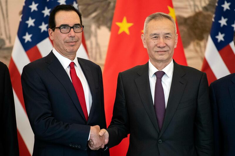 China's Vice Premier Liu He, right, shakes hands with U.S. Treasury Secretary Steven Mnuchin as they pose for a group photo at Diaoyutai State Guesthouse in Beijing Friday, March 29, 2019. (Nicolas Asfouri/Pool Photo via AP)