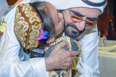 Sheikh Mohammed is embraced by Mahina Ghaniva, 9, from Tajikistan, who underwent heart surgery paid for by Dubai. Courtesy: Dubai Media Office