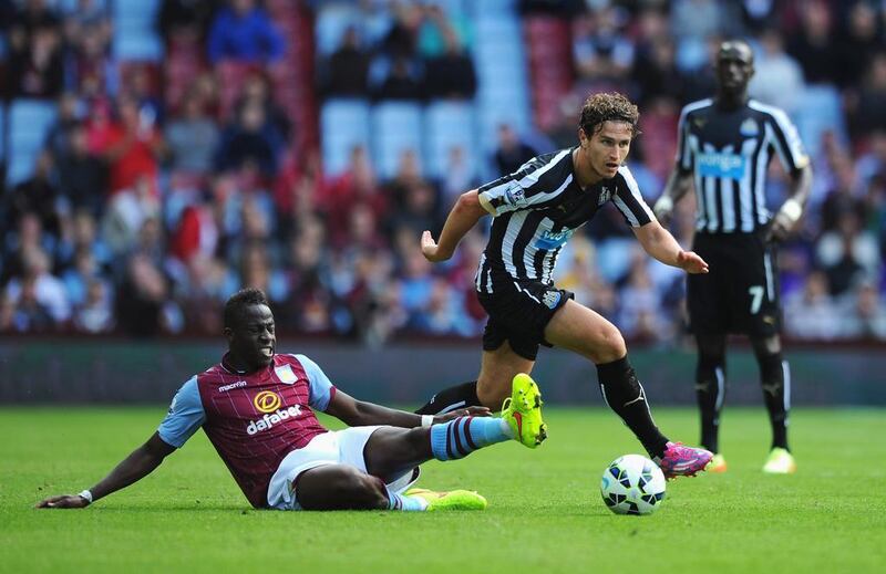 Daryl Janmaat of Newcastle United is tackled by Aly Cissokho of Aston Villa during the Barclays Premier League match between Aston Villa and Newcastle United at Villa Park on August 23, 2014 in Birmingham, England. (Photo by Chris Brunskill/Getty Images)