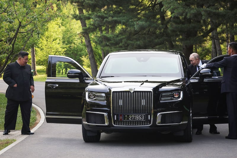Mr Putin presents a luxury car made by Russian maker Aurus to Mr Kim. EPA / Sputnik / Kremlin pool