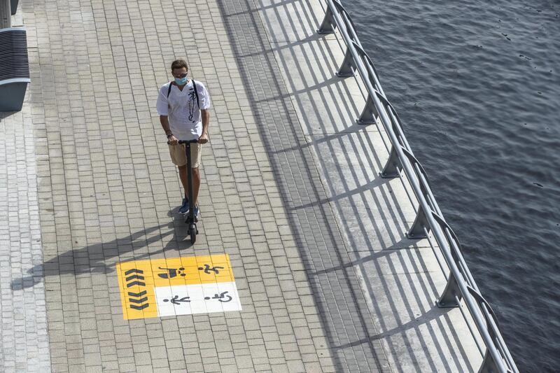 DUBAI, UNITED ARAB EMIRATES. 18 JULY 2020. Dubai Marina Walk now has new signs warning people not to go too fast on their bicycles or e-scooter along the promenade area. (Photo: Antonie Robertson/The National) Journalist: none. Section: National.