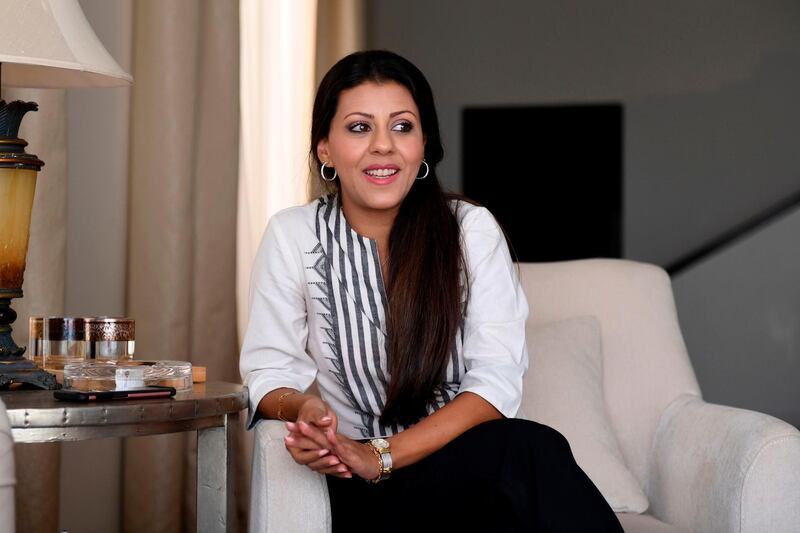Nouf Marwaai, 38, the head of the Arab Yoga Foundation, smiles as she poses in the western Saudi Arabian city of Jeddah on September 7, 2018. Widely perceived as a Hindu spiritual practice, yoga was not officially permitted for decades in Saudi Arabia, the cradle of Islam where all non-Muslim worship is banned. But with Crown Prince Mohammed bin Salman vowing an "open, moderate Islam", the kingdom last November recognised yoga as a sport, despite the risk of riling hardliners opposed to the practice. / AFP / Amer HILABI
