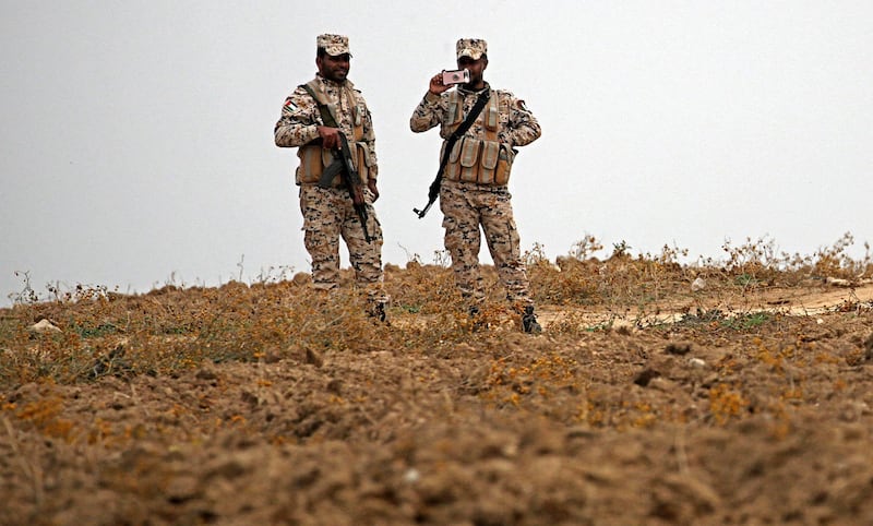 epa06409535 Hamas security forces stand guard during a protest at the east of Jabaliya refugee camp, near the border between Israel and Gaza Strip, in northern Gaza Strip, 29 December 2017.  The protest is to mark the birthday of the Israeli soldier Oron Shaul who was captured and killed during the 2014 Gaza war (also known as Operation Protective Edge); his remains is part of an indirect negotiations talk for prisoners exchange between Israel and Hamas.  EPA/MOHAMMED SABER