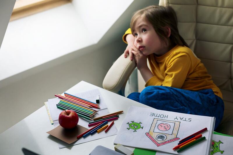 Sad child in isolation at home for virus outbreak. Sadness. Depression. Loneliness.